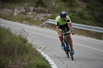 Image showing triathlon athlete riding bike