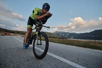 Image showing triathlon athlete riding bike