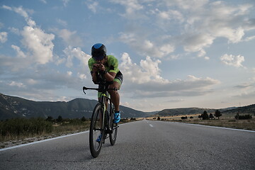 Image showing triathlon athlete riding bike