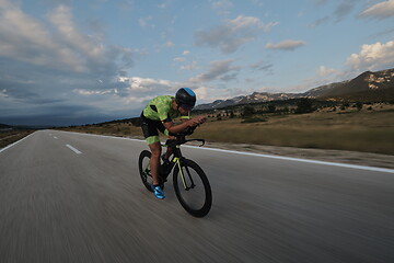 Image showing triathlon athlete riding bike