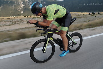 Image showing triathlon athlete riding bike