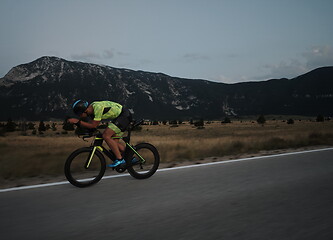 Image showing triathlon athlete riding bike