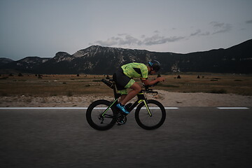 Image showing triathlon athlete riding bike