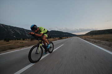 Image showing triathlon athlete riding bike