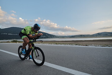 Image showing triathlon athlete riding bike