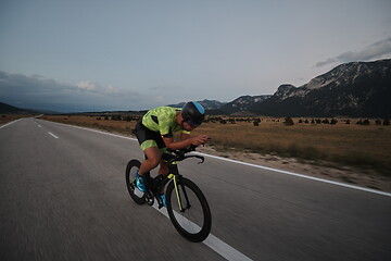 Image showing triathlon athlete riding bike