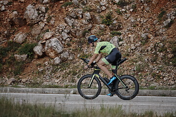 Image showing triathlon athlete riding bike