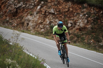 Image showing triathlon athlete riding bike