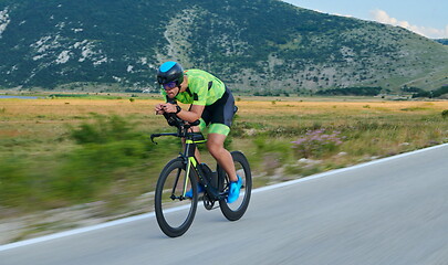 Image showing triathlon athlete riding bike