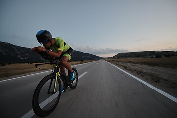 Image showing triathlon athlete riding bike