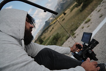 Image showing cinematographer taking action shot of triathlon bike athlete