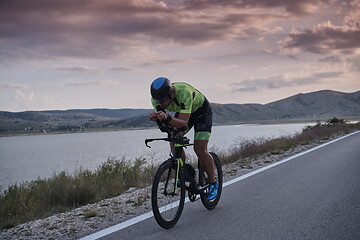 Image showing triathlon athlete riding bike