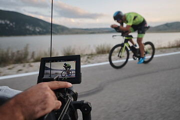 Image showing cinematographer taking action shot of triathlon bike athlete