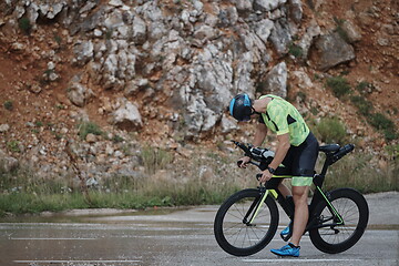 Image showing triathlon athlete riding bike