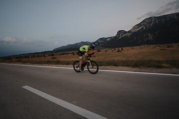 Image showing triathlon athlete riding bike