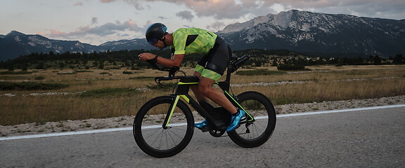 Image showing triathlon athlete riding bike