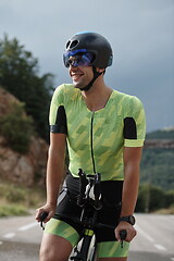 Image showing triathlon athlete riding bike