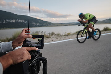 Image showing cinematographer taking action shot of triathlon bike athlete