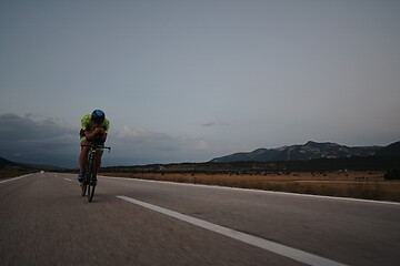 Image showing triathlon athlete riding bike