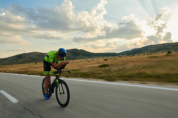 Image showing triathlon athlete riding bike