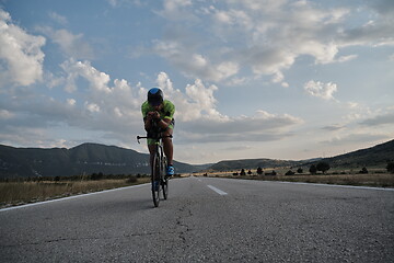 Image showing triathlon athlete riding bike