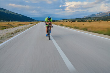 Image showing triathlon athlete riding bike