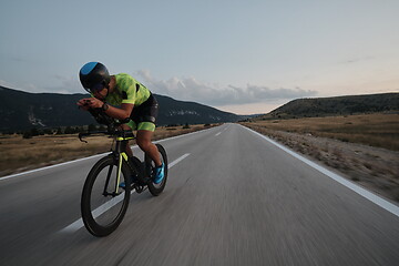 Image showing triathlon athlete riding bike