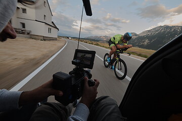 Image showing cinematographer taking action shot of triathlon bike athlete