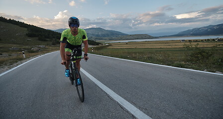 Image showing triathlon athlete riding bike