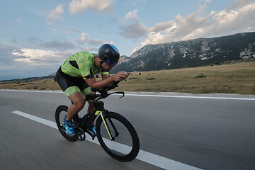 Image showing triathlon athlete riding bike