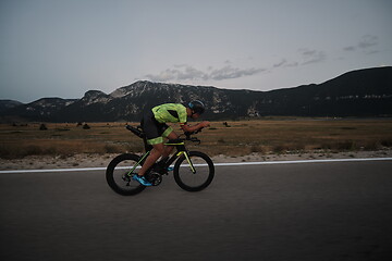 Image showing triathlon athlete riding bike