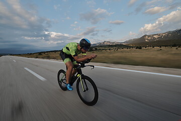 Image showing triathlon athlete riding bike