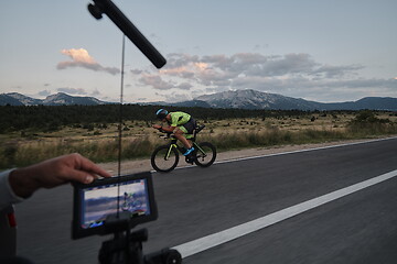 Image showing cinematographer taking action shot of triathlon bike athlete