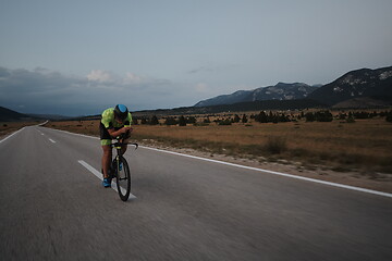 Image showing triathlon athlete riding bike