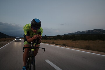 Image showing triathlon athlete riding bike