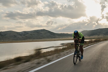 Image showing triathlon athlete riding bike