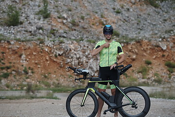 Image showing triathlon athlete riding bike