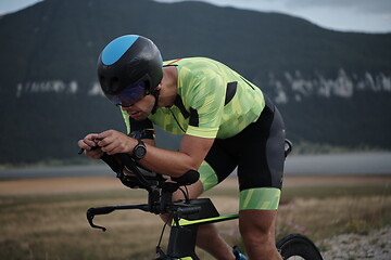 Image showing triathlon athlete riding bike