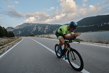 Image showing triathlon athlete riding bike