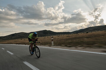 Image showing triathlon athlete riding bike