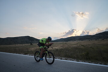 Image showing triathlon athlete riding bike