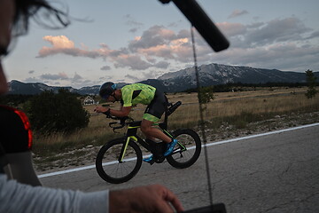 Image showing cinematographer taking action shot of triathlon bike athlete