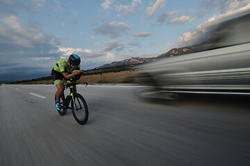 Image showing triathlon athlete riding bike