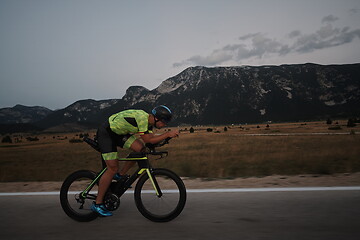 Image showing triathlon athlete riding bike