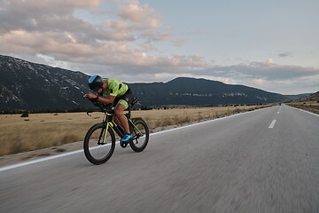 Image showing triathlon athlete riding bike