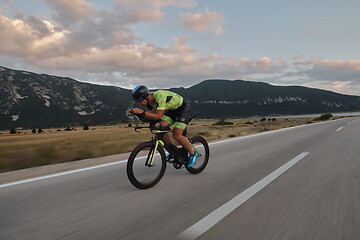 Image showing triathlon athlete riding bike