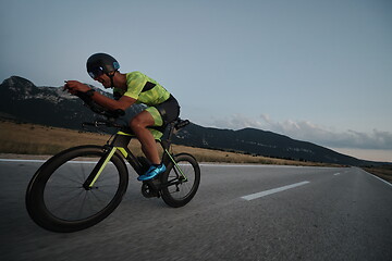 Image showing triathlon athlete riding bike