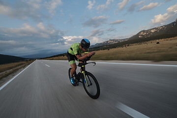 Image showing triathlon athlete riding bike