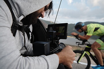 Image showing cinematographer taking action shot of triathlon bike athlete