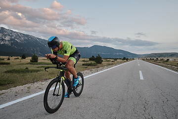 Image showing triathlon athlete riding bike